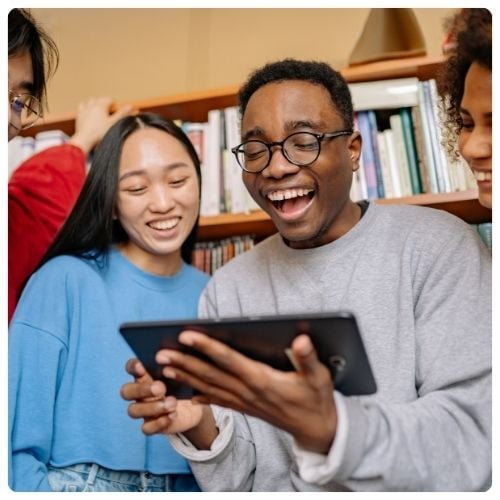 smiling teens looking at tablet